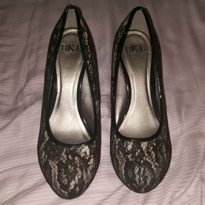 Black lace covered nude pumps